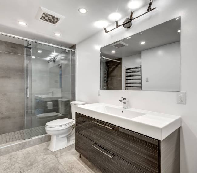 Sleek, contemporary bathroom design featuring walk-in shower and floating vanity by Bathroom Renovations West Auckland.